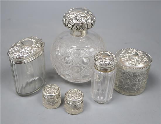 A late Victorian silver mounted cut glass scent bottle, Chester, 1900 and five silver mounted toilet jars.